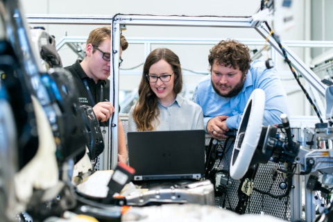 Image of people working on a computer