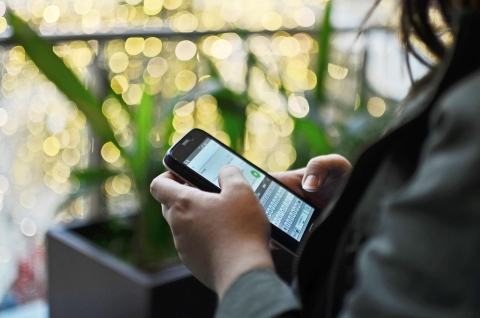 Image of woman using her phone
